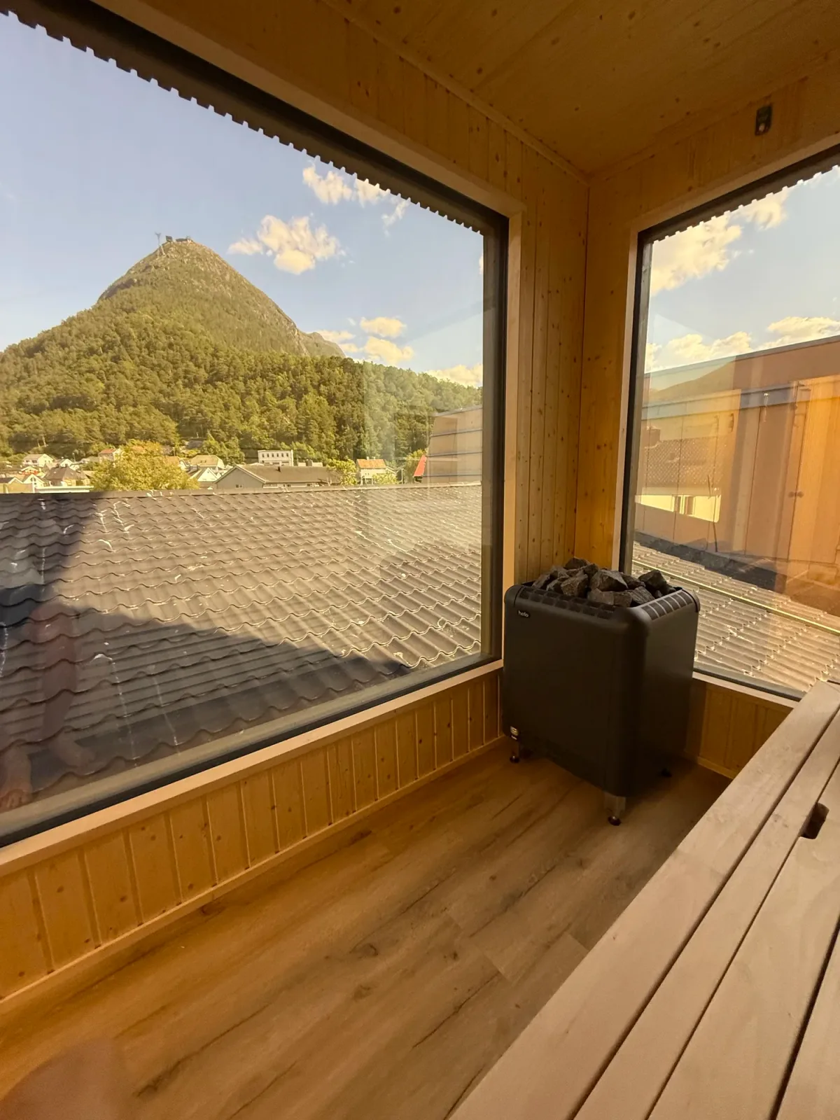 Sauna cabin in the Romsdalen valley with dramatic mountain walls rising behind